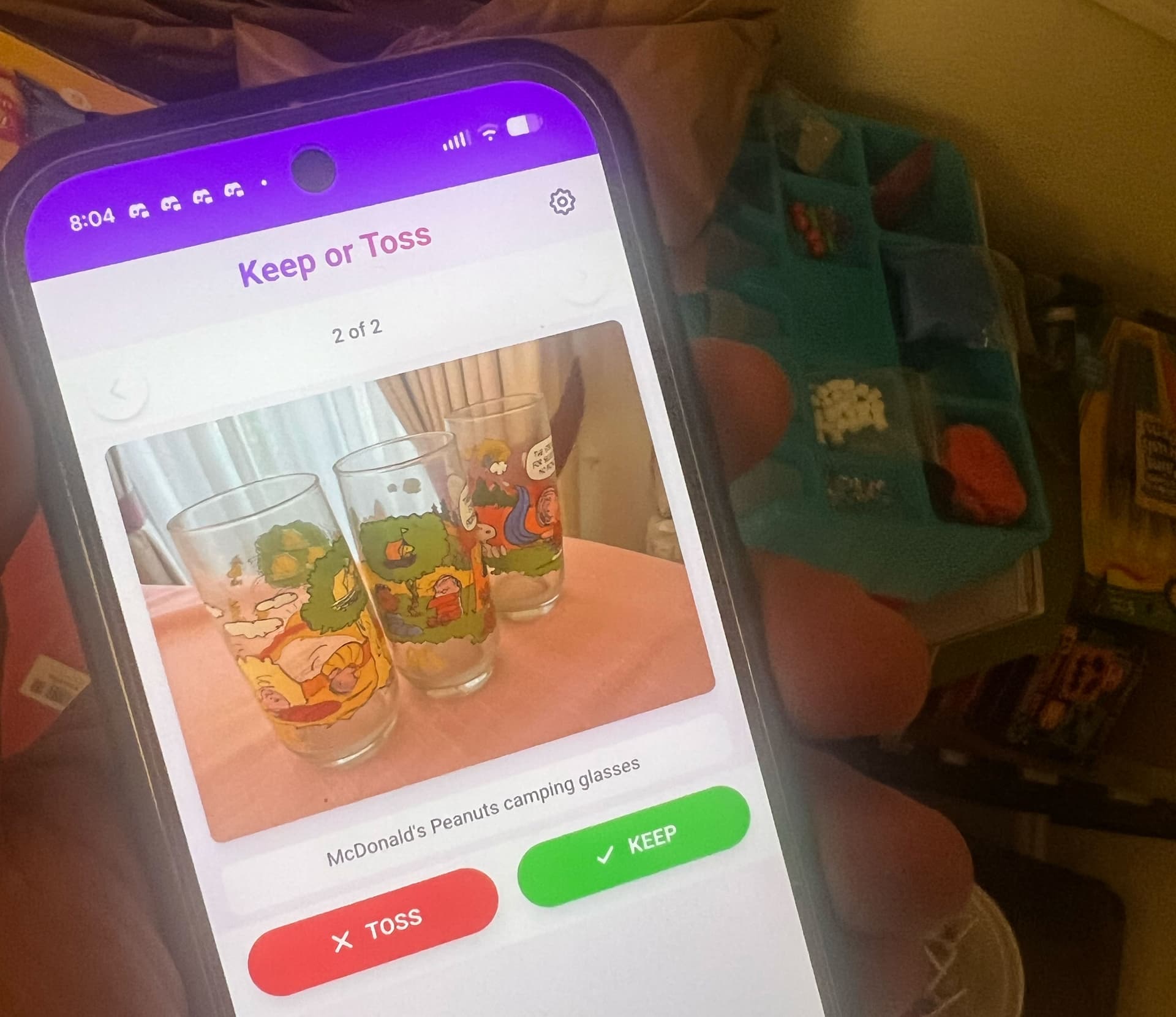 Screenshot of Tinder for Stuff app showing a swipe interface with Keep and Toss buttons