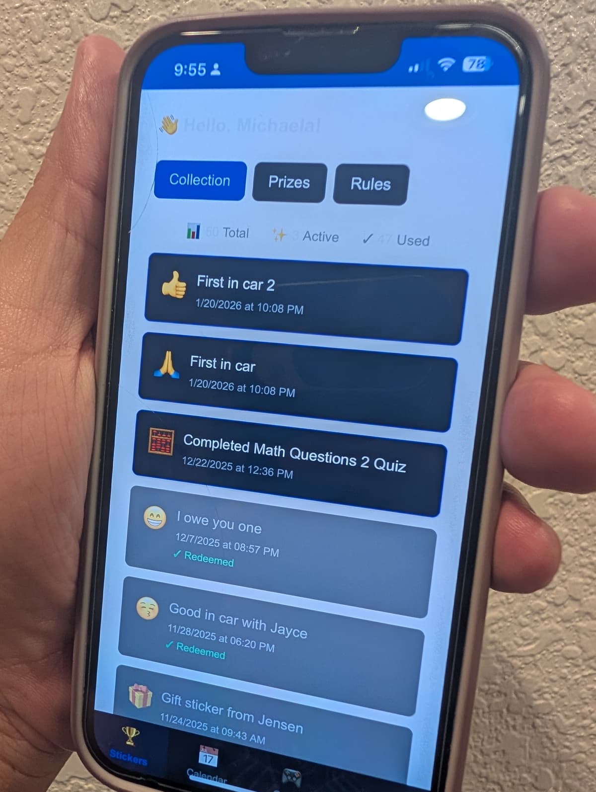 Hand holding iPhone showing the Chang Family App sticker collection screen