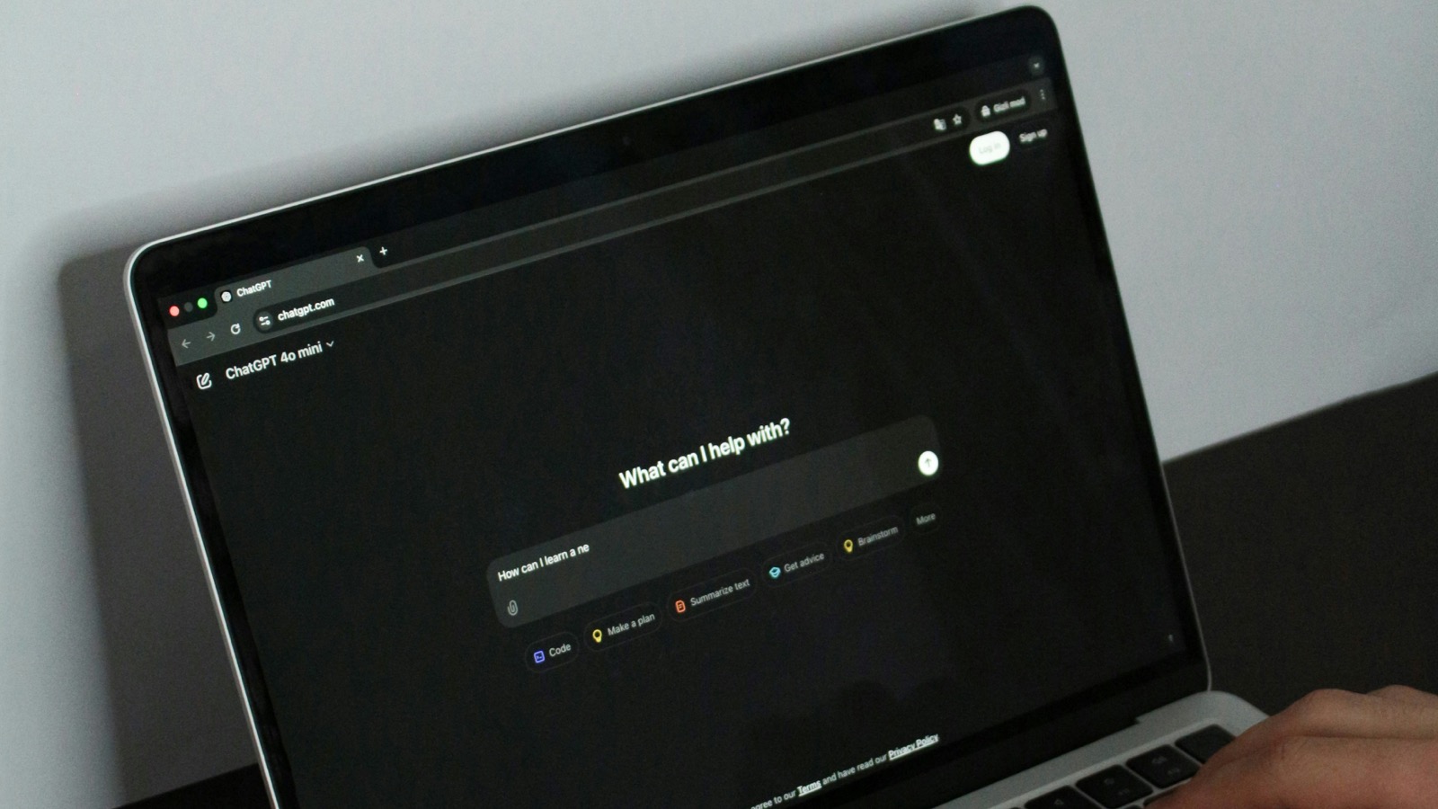 Laptop showing ChatGPT interface with "What can I help with?" prompt